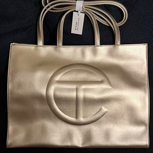 Telfar large gold shopping bag. Never used. Brand new